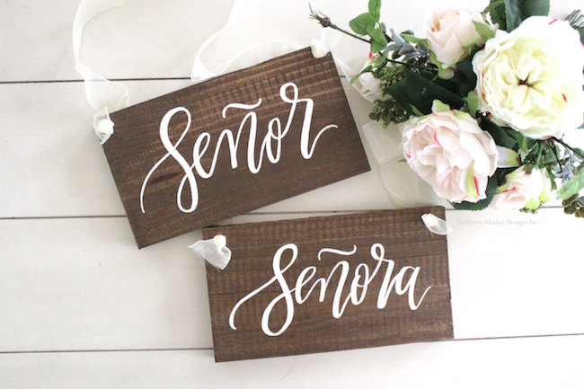 Lazer cut script style calligraphy Mr Mrs Wedding Chair Signs. See 20 more cute and creative ideas here: https://confettidaydreams.com/mr-and-mrs-signs/